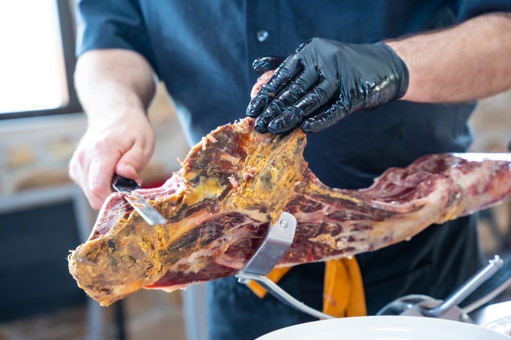 A serrano ham cutter at an event